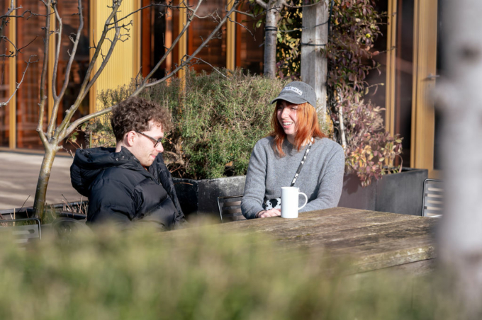Deux personnes parlant sur une terrasse