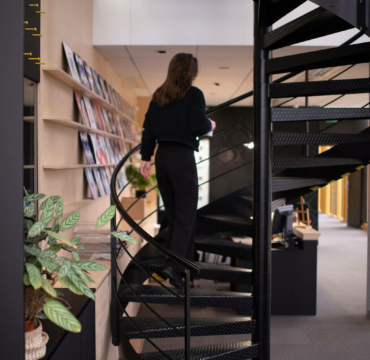 Woman who is climbing stairs in an office