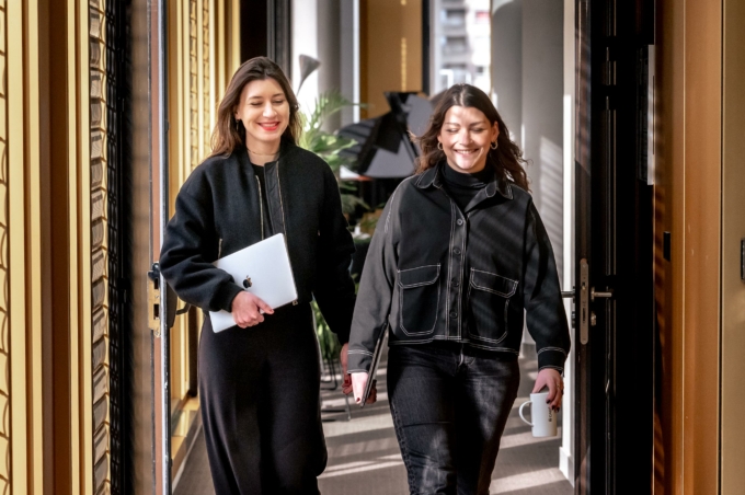 Deux femmes marchant dans un couloir avec le sourire